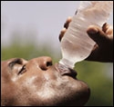 Black man drinking from a water bottle