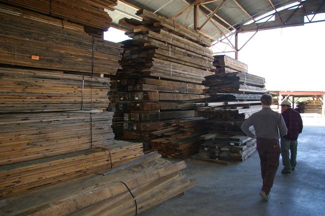 Tad Mason & Marc Mandel look at the inventory of reclaimed lumber