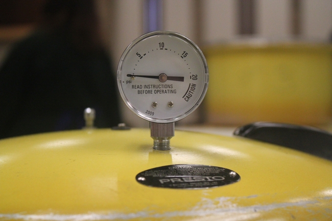 Pressure gauge on canner lid.
