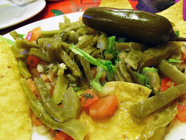 Nopales cooked with other vegetables and tortillas.
