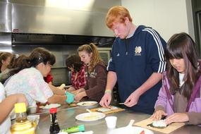 4-H participants learn to make sushi. Nutrition education is often a part of 4-H projects.